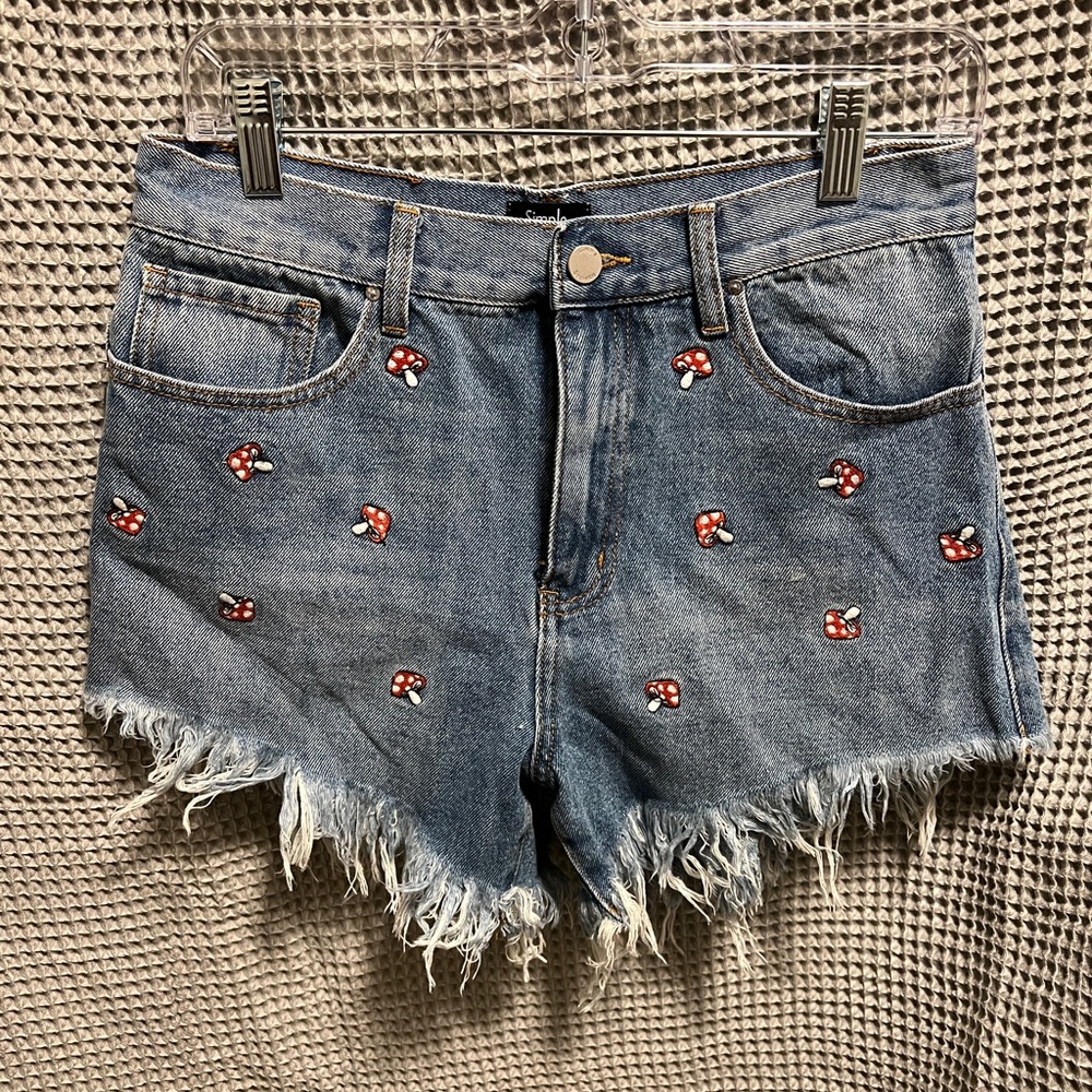 Embroidered mushroom distressed jean shorts